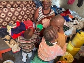 Children and a woman sorting donated clothing